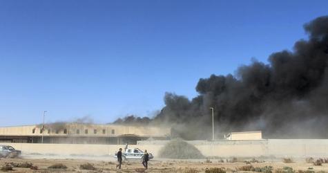 Black smoke billows from a warehouse after an airstrike in Zawura