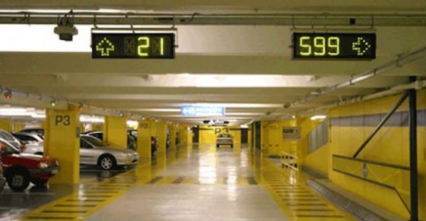 الصورة الاخرى توضح استخدام التقنيات الحديثة لادارة الحركة المرورية داخل مواقف السيارات متعددة الطوابق.