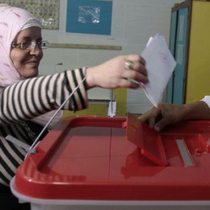 A woman casts her ballot at a polling station during an election in Tunis