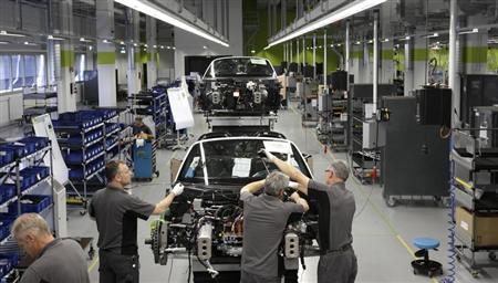 Electricians assemble new Porsche 918-Spyder sports car at production line of German car manufacturer's plant in Stuttgart