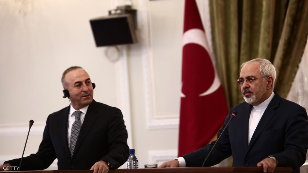 جاوش أوغلو ونظيره الإيراني في مؤتمر صحفي مشترك بطهران عام 2014 - أرشيفية