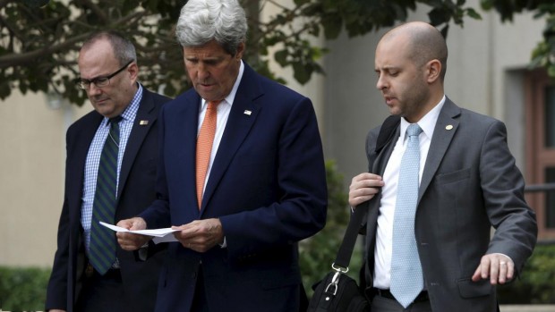 Kerry walks with staff as he departs the U.S. Embassy in Manama, Bahrain