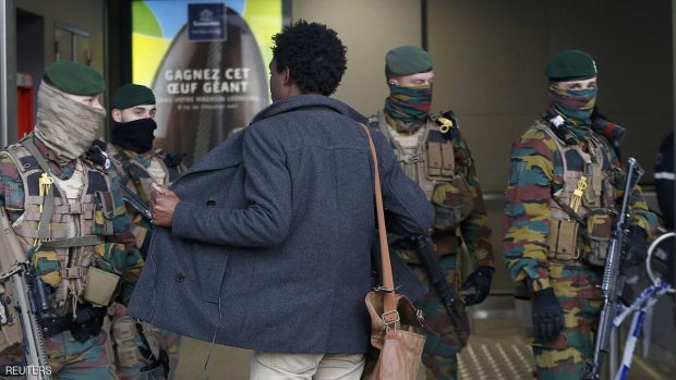 A man is searched by soldiers at the entrace to a Brussels subway station following Tuesday's bombings in Brussels.