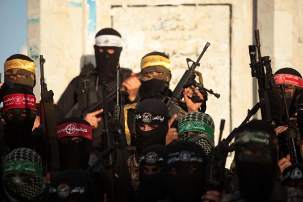 Palestinians militants from various armed factions, including Hamas, attend a news conference in Gaza City