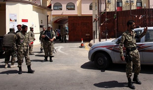 Libyan security forces secure the area outside the al-Hadba prison and tribunal facility at the end of the first hearing of the trial of former Libyan foreign intelligence chief Bouzid Dorda in Tripoli on June 5, 2012. A trial of former officials in Moamer Kadhafi's regime opened in Libya, with Dorda, who is charged with detaining people without evidence of any crimes and using or threatening force to prevent others from enjoying their political rights, was the first to appear in the dock. AFP PHOTO/MAHMUD TURKIA