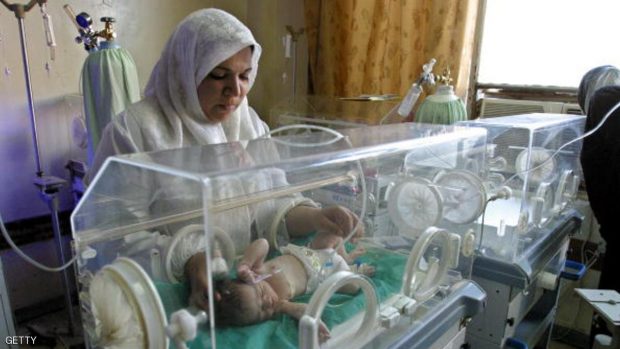 An Iraqi nurse tends a baby inside a new